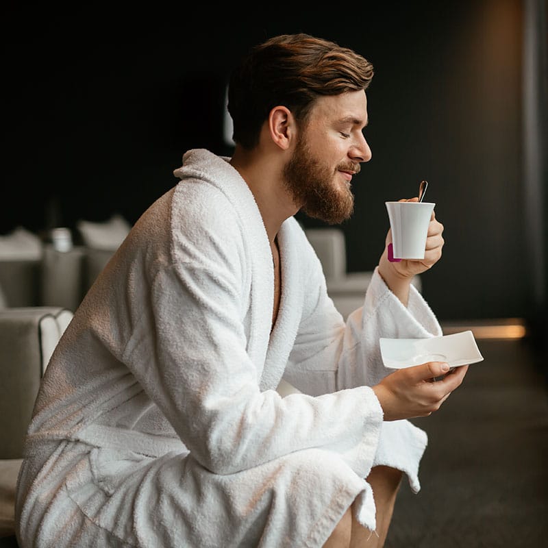 Man drinking tea in hotel