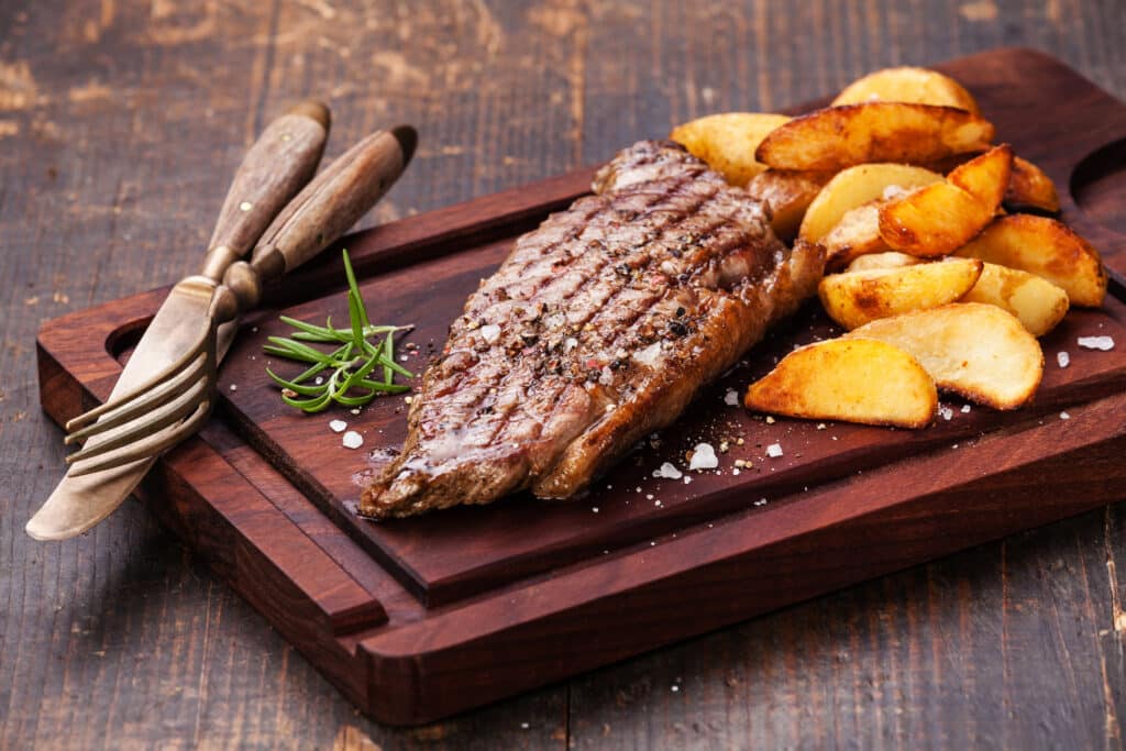 Well Done Grilled New York Steak With Roasted Potato Wedges